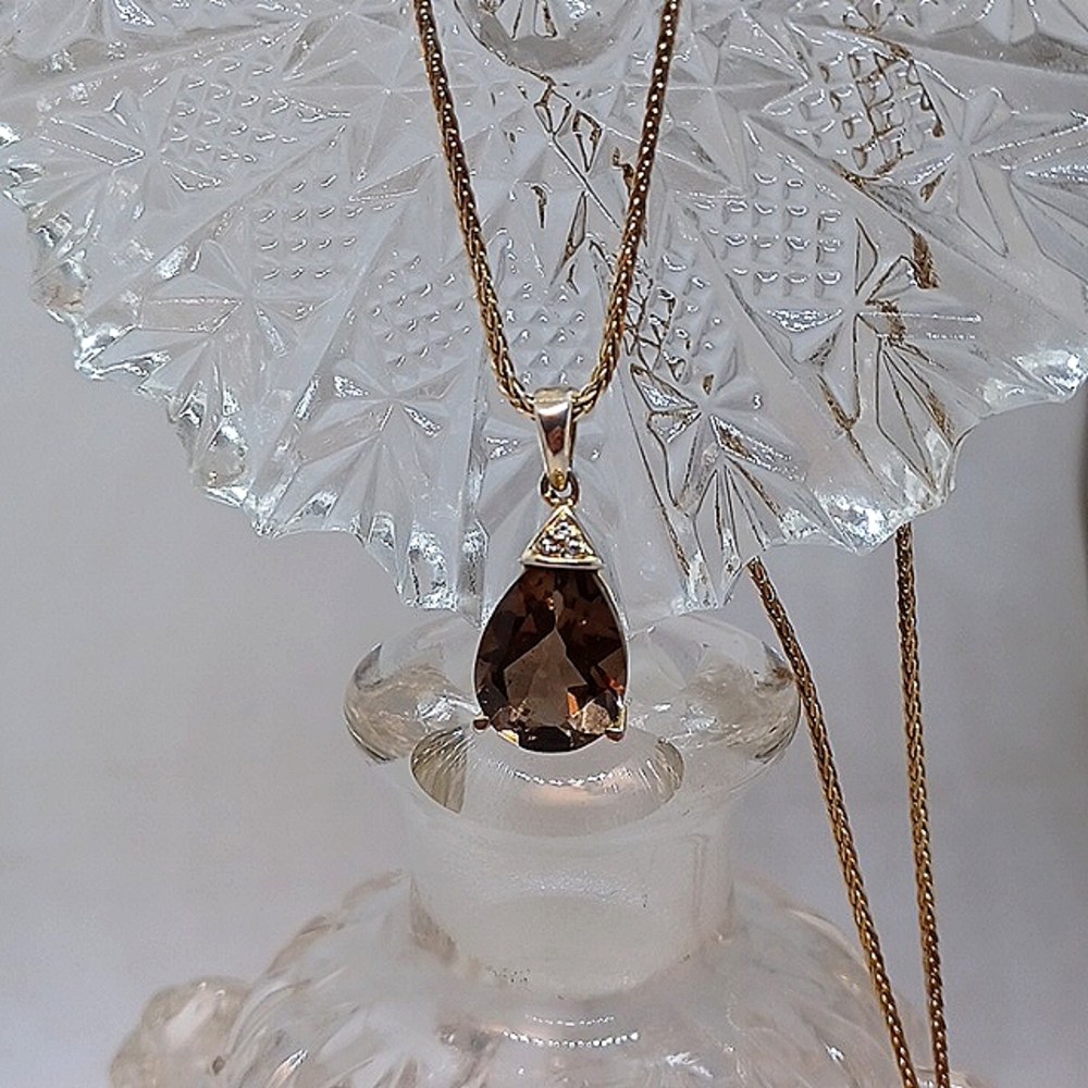 10k over Silver 30inch chain with a smokey topaz pendant.